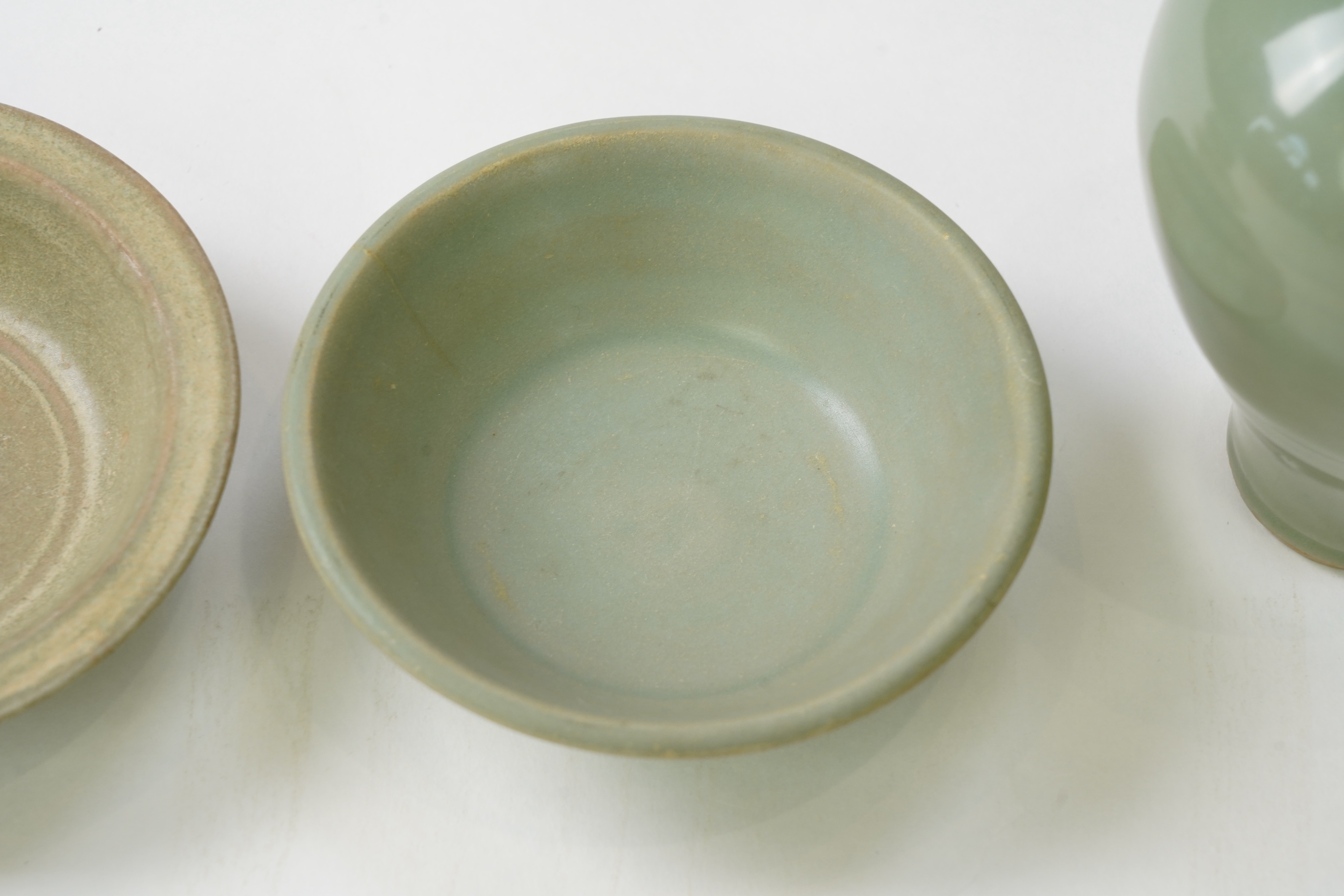 A group of four Chinese Celadon wares - two vases and two dishes, tallest vase 16cm.